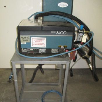 NORDSON 3400 sticker on stainless steel platform